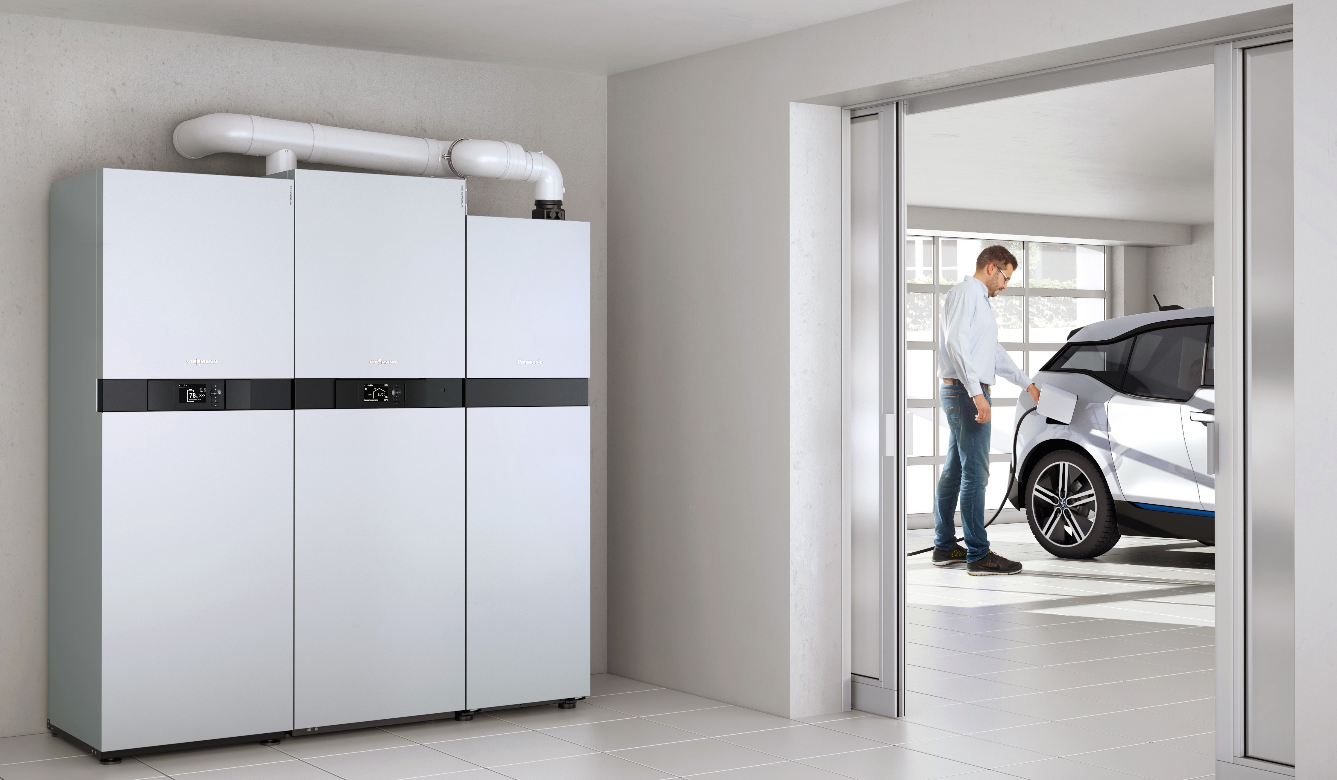 Neue Heizung: Brennstoffzelle im Nebenraum einer Garage, Mann tankt E-Auto