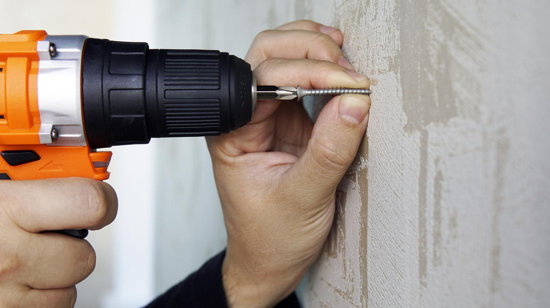 Bohrmaschine an Wand angesetzt