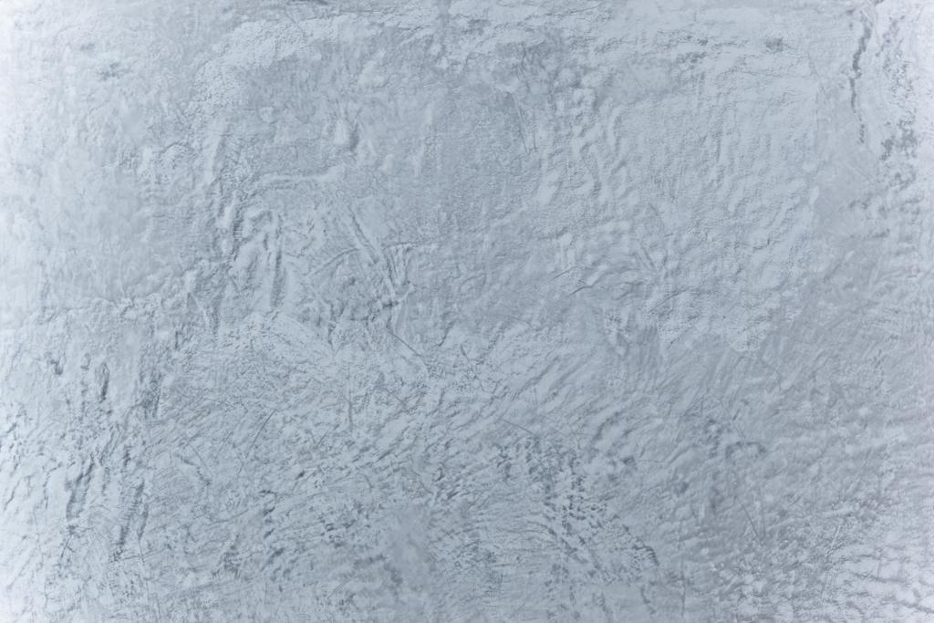 Grau verputzte Wand im Betonlook.