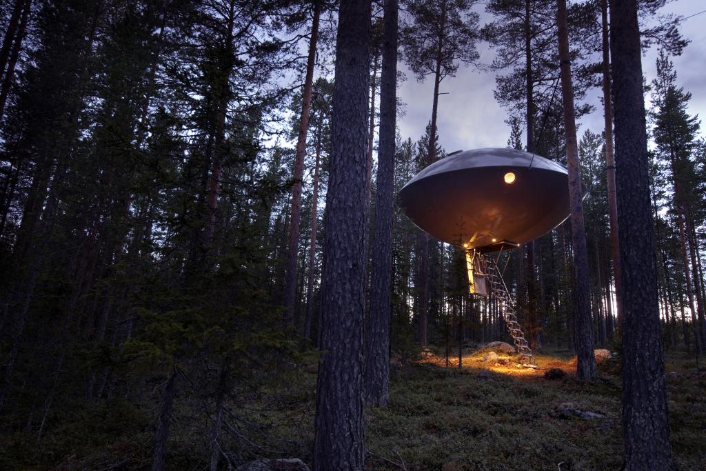 Baumhaus in Form eines Ufos mitten im Wald.