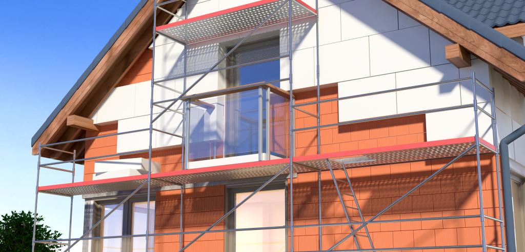 Wärmedämmverbundsysteme: Außenfassade eines Hauses wird mit WDVS beklebt.