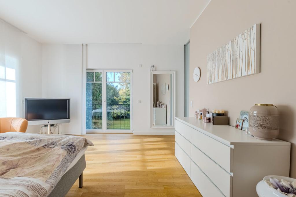 Großzügiges Schlafzimmer mit Blick in den Garten