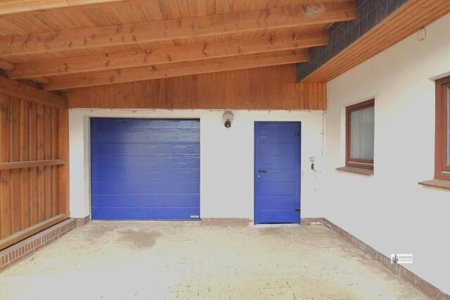 Carport vor der Garage mit Werkstattraum